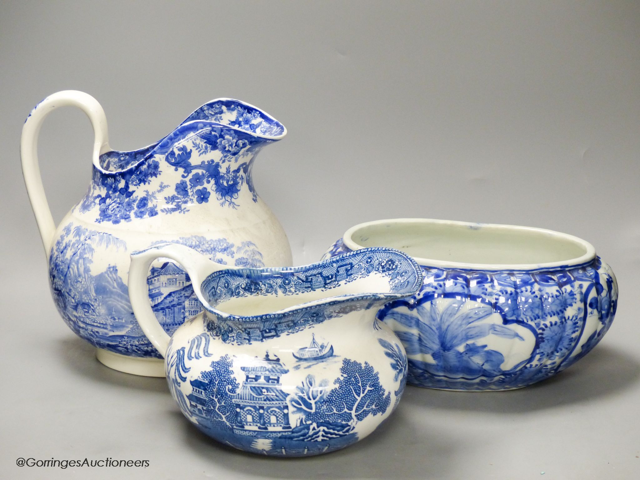 A Mintons blue and white jug, another and a Japanese blue and white jardiniere, tallest 24cm